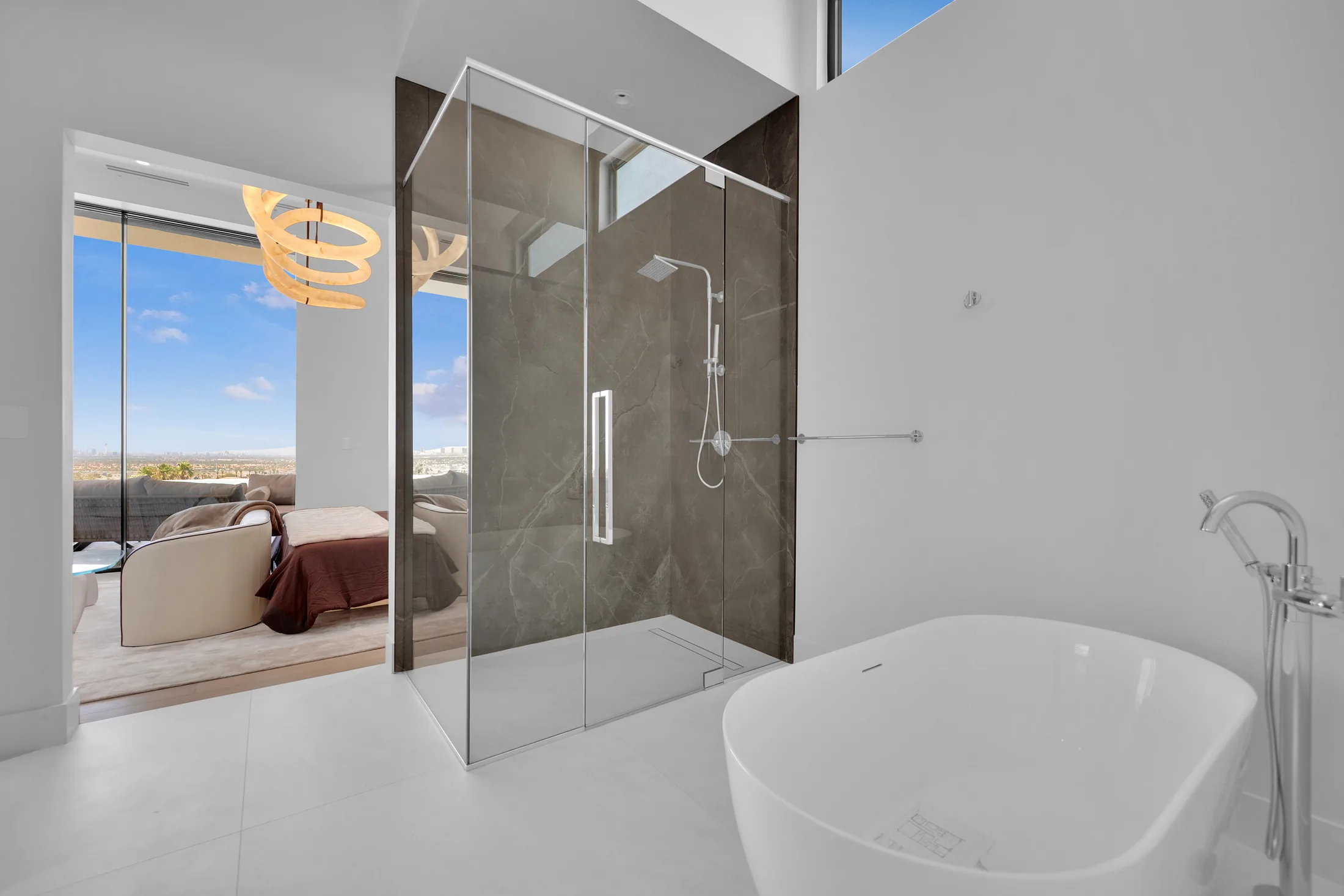 Livv primary bath with porcelain slab and frameless glass shower